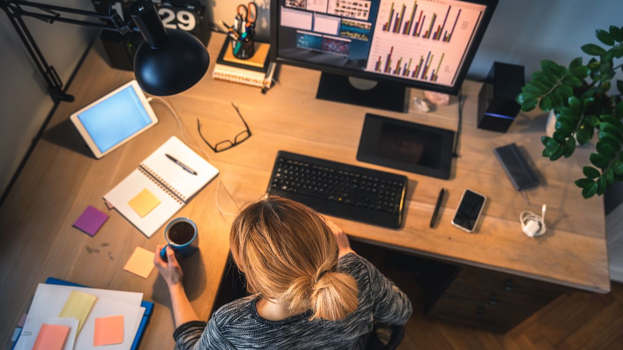 Woman working at desk STOCK